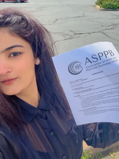 Dr. Anam Shahid holding her ASPPB score report